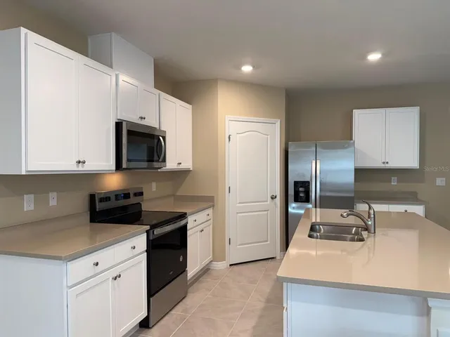 a kitchen with a sink a stove and refrigerator