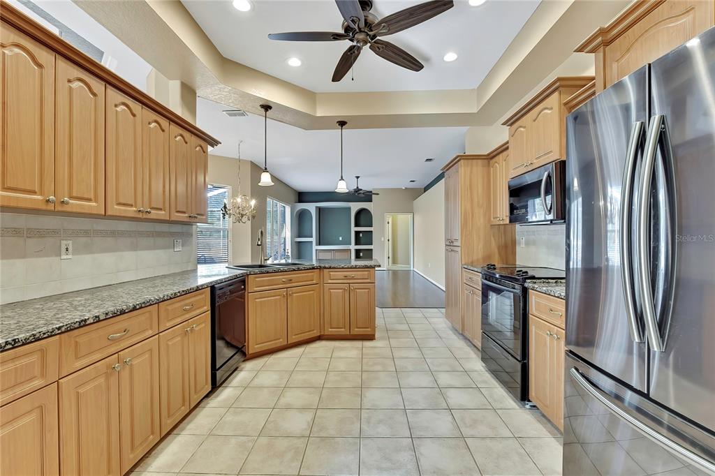12403 Centennial Street Spring Hill, FL 34609 - Photo 15 of 62 a kitchen with stainless steel appliances granite countertop a refrigerator a sink and dishwasher