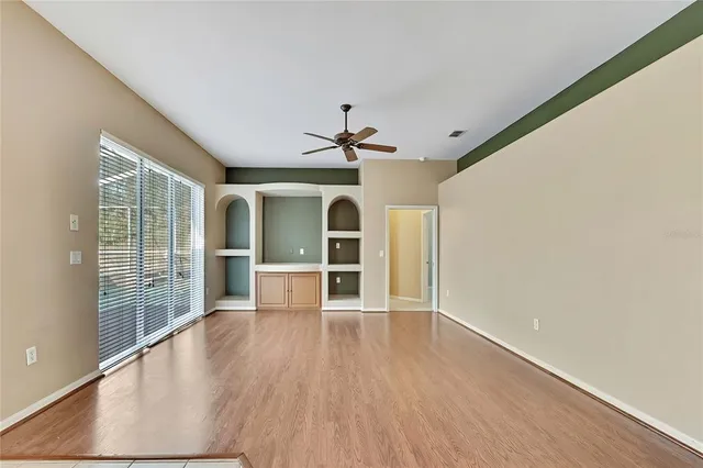 a view of a room with wooden floor