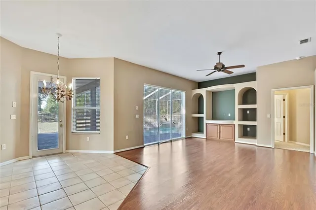 a view of a kitchen with a sink and refrigerator wooden floor