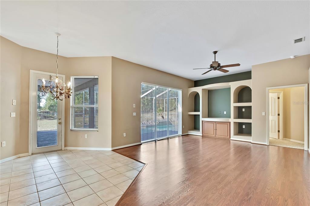 12403 Centennial Street Spring Hill, FL 34609 - Photo 21 of 62 a view of an empty room with window and wooden floor