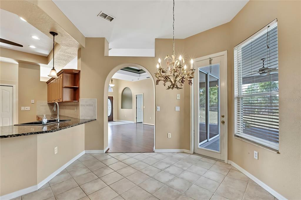 12403 Centennial Street Spring Hill, FL 34609 - Photo 24 of 62 a view of a kitchen with a sink and refrigerator wooden floor