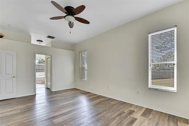 a bathroom with a granite countertop sink a large mirror and a bathtub