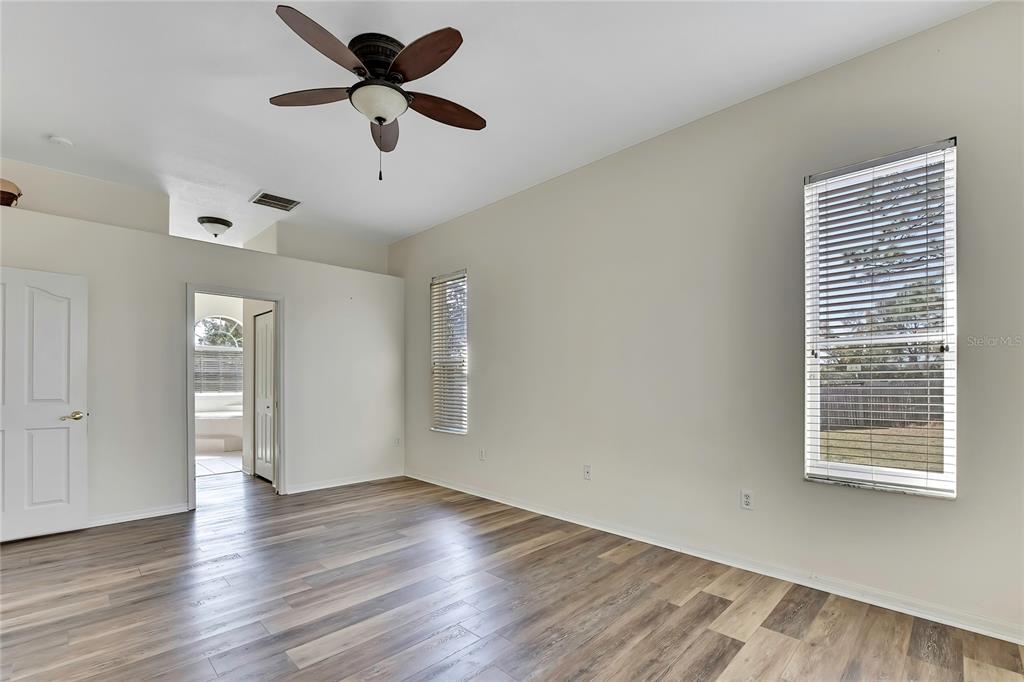 12403 Centennial Street Spring Hill, FL 34609 - Photo 26 of 62 a view of an empty room with a window and wooden floor