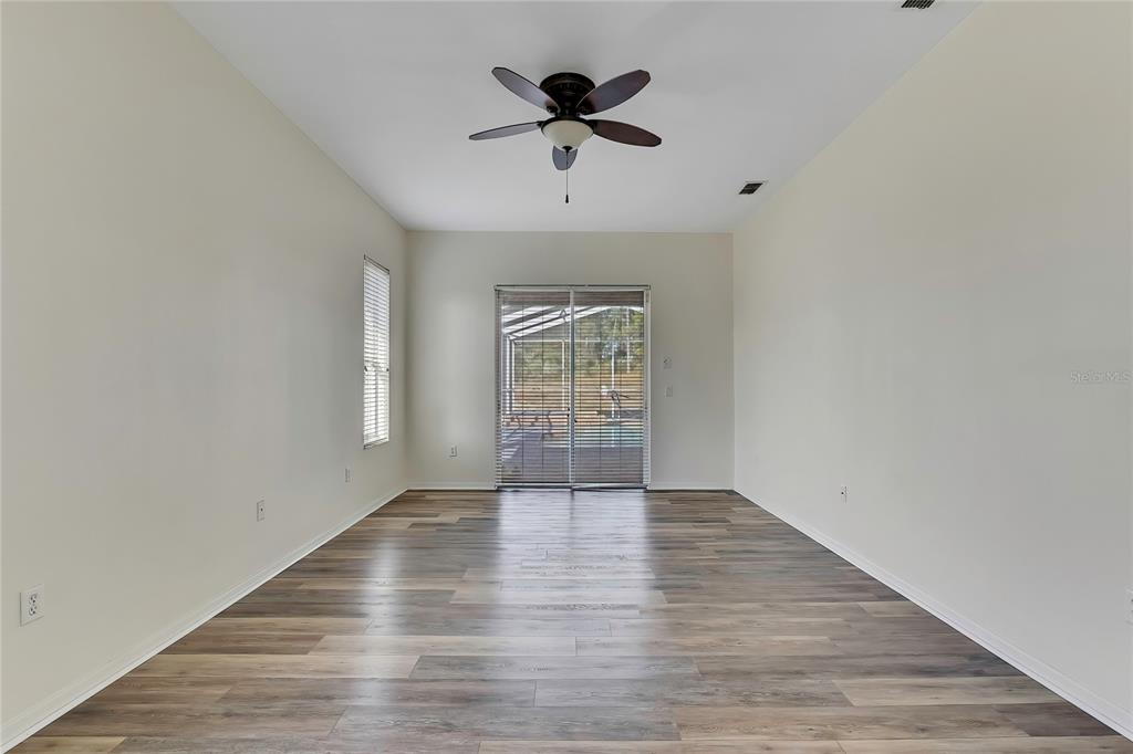 12403 Centennial Street Spring Hill, FL 34609 - Photo 28 of 62 wooden floor in an empty room with a window