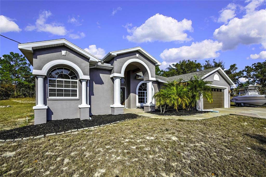 12403 Centennial Street Spring Hill, FL 34609 - Photo 4 of 62 a front view of a house with a yard