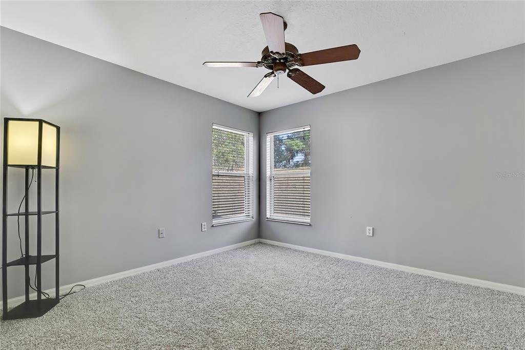 12403 Centennial Street Spring Hill, FL 34609 - Photo 41 of 62 an empty room with windows and fan