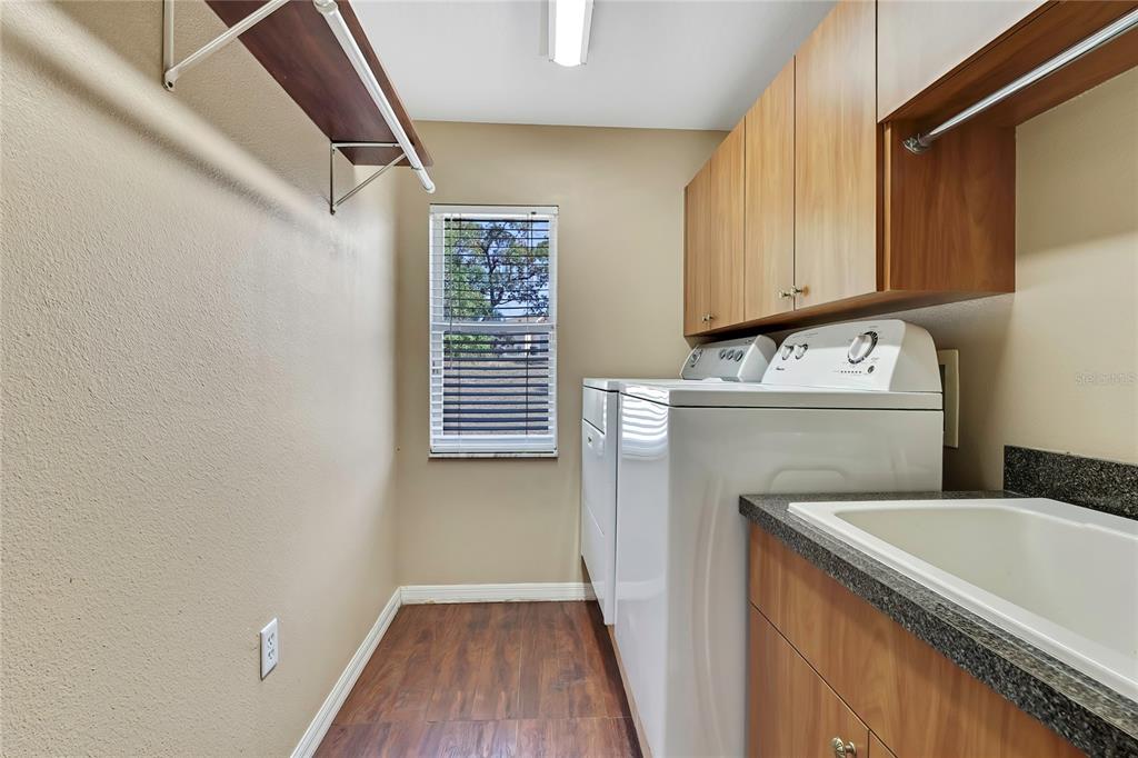 12403 Centennial Street Spring Hill, FL 34609 - Photo 47 of 62 a kitchen with a sink cabinets and a wooden floor