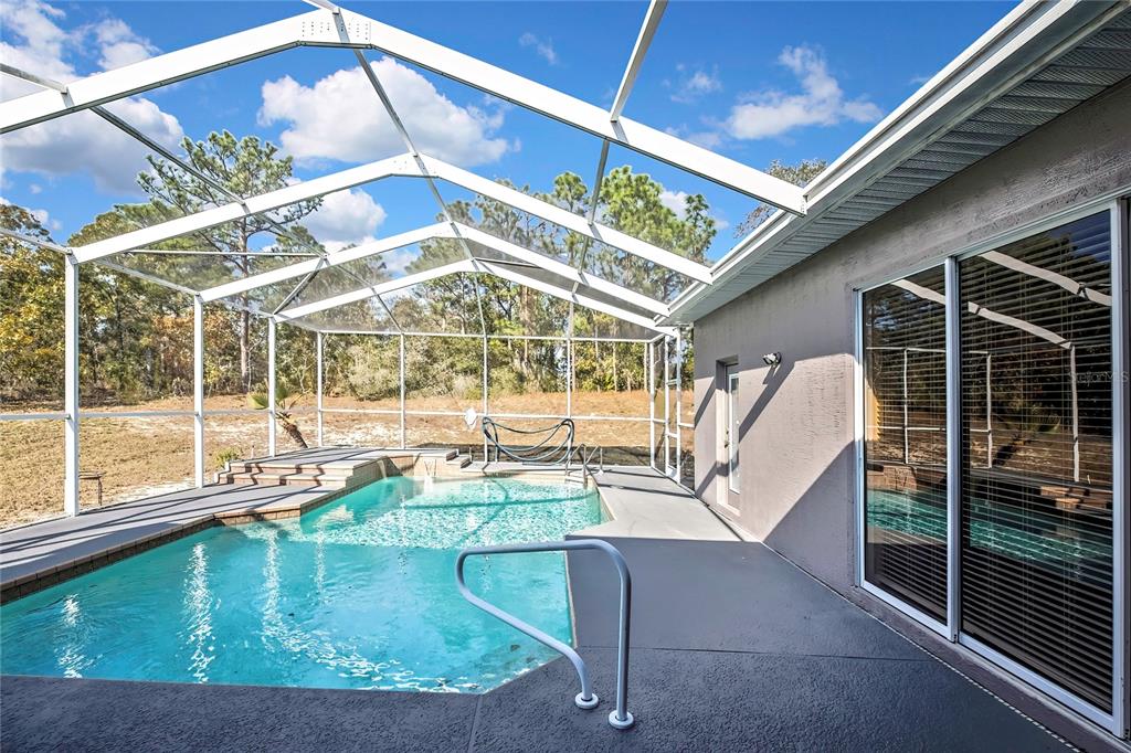 12403 Centennial Street Spring Hill, FL 34609 - Photo 49 of 62 a view of a house with a swimming pool