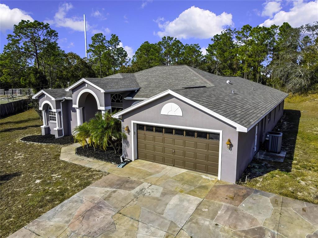 12403 Centennial Street Spring Hill, FL 34609 - Photo 5 of 62 a front view of a house with a yard and garage