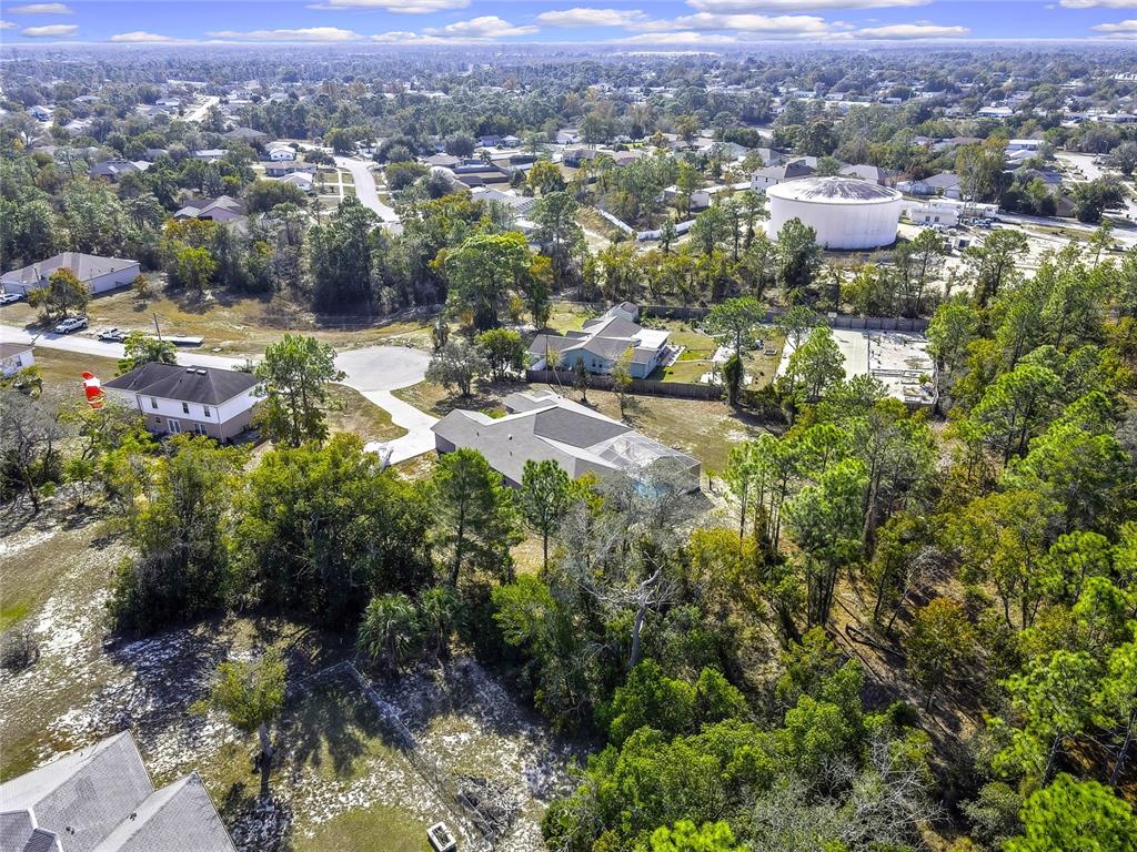 12403 Centennial Street Spring Hill, FL 34609 - Photo 56 of 62 an aerial view of residential houses with outdoor space and trees
