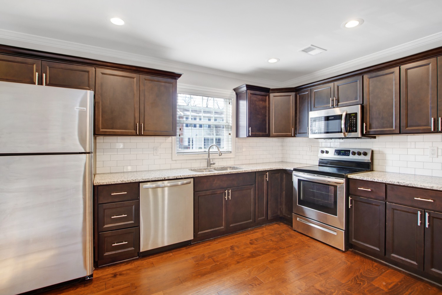 113 Cages Road, Unit 3 Hendersonville, TN 37075 - Photo 12 of 30 a kitchen with stainless steel appliances granite countertop a stove top oven a sink and dishwasher a refrigerator with wooden floor