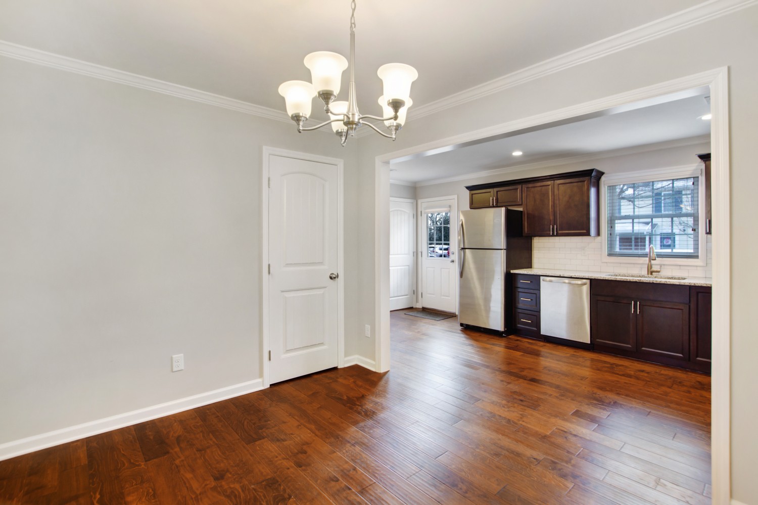 113 Cages Road, Unit 3 Hendersonville, TN 37075 - Photo 8 of 30 a open kitchen with stainless steel appliances granite countertop a refrigerator oven a sink dishwasher and white cabinets with wooden floor