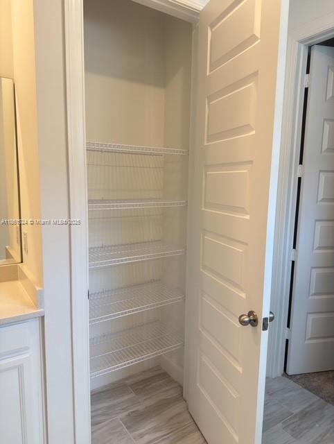 6576 Cloverdale Avenue Port St. Lucie, FL 34987 - Photo 11 of 32 a view of walk in closet with empty racks