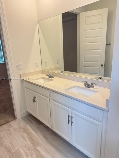 6576 Cloverdale Avenue Port St. Lucie, FL 34987 - Photo 12 of 32 a bathroom with a granite countertop sink and a mirror