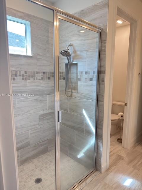6576 Cloverdale Avenue Port St. Lucie, FL 34987 - Photo 13 of 32 a bathroom with a glass shower door and a bathroom