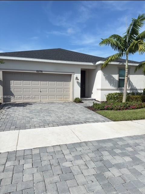6576 Cloverdale Avenue Port St. Lucie, FL 34987 - Photo 2 of 32 a view of entrance gate of the house