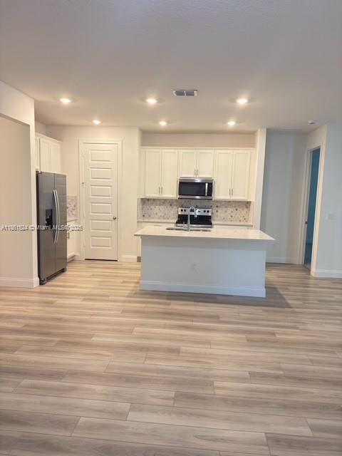 6576 Cloverdale Avenue Port St. Lucie, FL 34987 - Photo 27 of 32 a view of kitchen with stainless steel appliances granite countertop a stove and a refrigerator