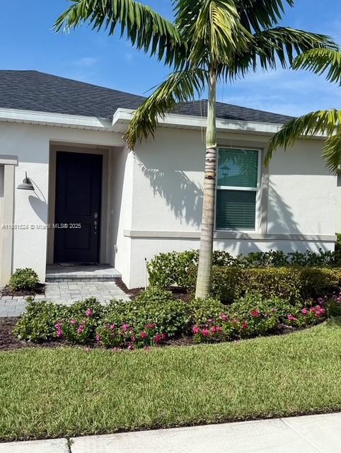 6576 Cloverdale Avenue Port St. Lucie, FL 34987 - Photo 3 of 32 a front view of yellow house with a small yard