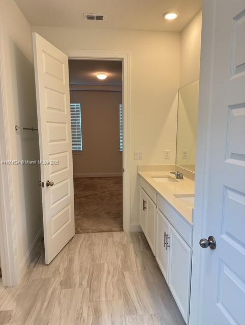 6576 Cloverdale Avenue Port St. Lucie, FL 34987 - Photo 10 of 32 a bathroom with a granite countertop sink and a mirror