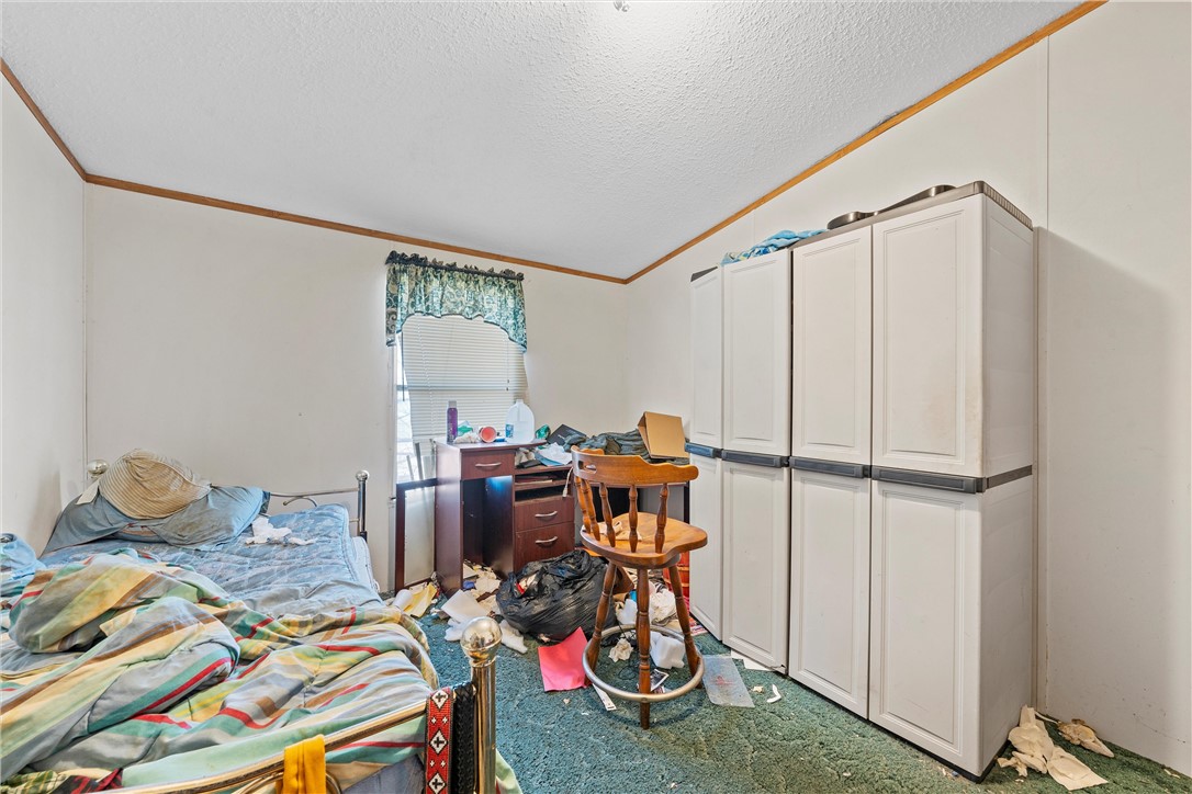 3725 Bluhm Road West, TX 76691 - Photo 11 of 26 a bedroom with furniture and a gym equipment
