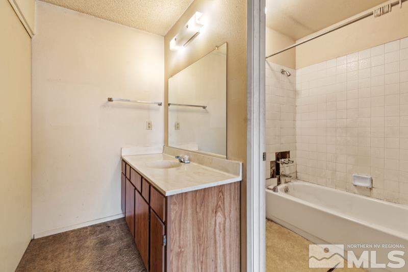 1376 Butler Street Reno, NV 89512 - Photo 8 of 12 a bathroom with a sink and a mirror