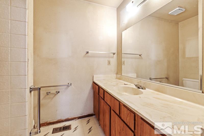 1376 Butler Street Reno, NV 89512 - Photo 10 of 12 a bathroom with a sink and a mirror