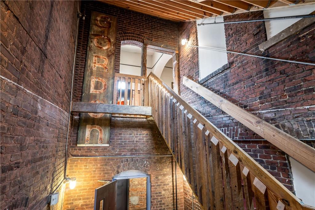 215 Mitchell Street Southwest, Unit 14 Atlanta, GA 30303 - Photo 11 of 37 a view of balcony with wooden floor and brick walls
