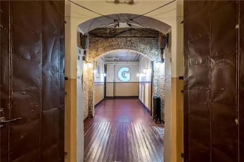 a view of a room that has a large window and a refrigerator