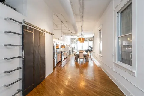 a kitchen with sink a counter and chairs