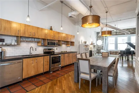 a kitchen with stainless steel appliances granite countertop a refrigerator and a stove top oven