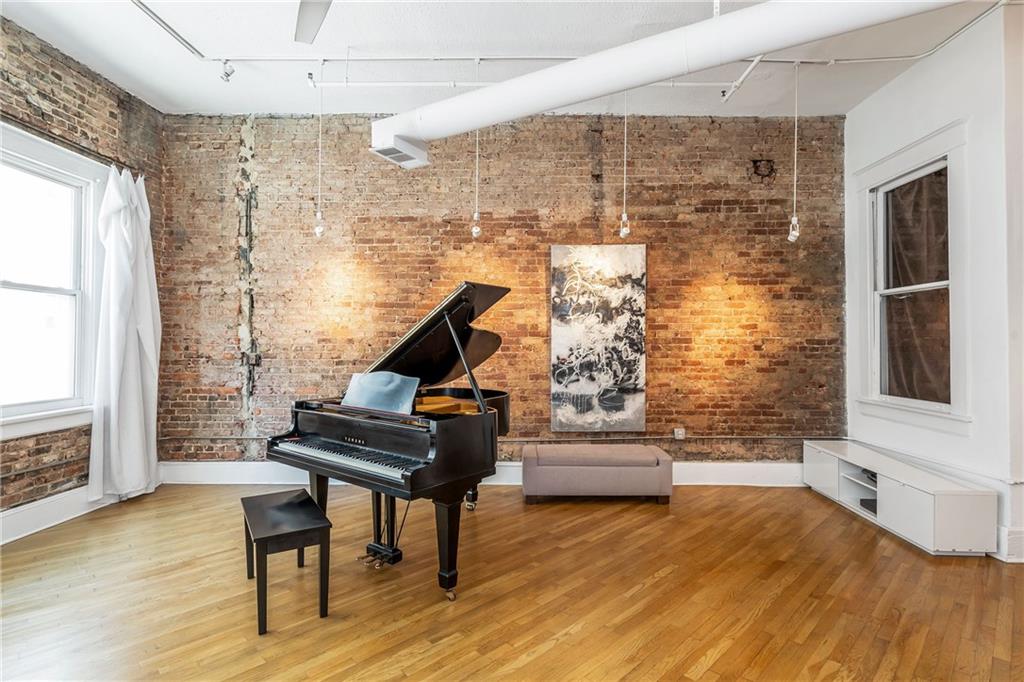 215 Mitchell Street Southwest, Unit 14 Atlanta, GA 30303 - Photo 21 of 37 a living room with furniture and a wooden floor