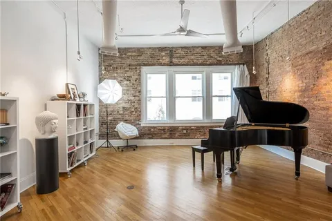 a bathroom with a granite countertop sink and a window