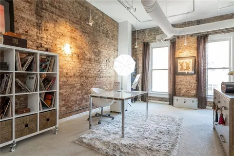 a dining room with furniture and a window