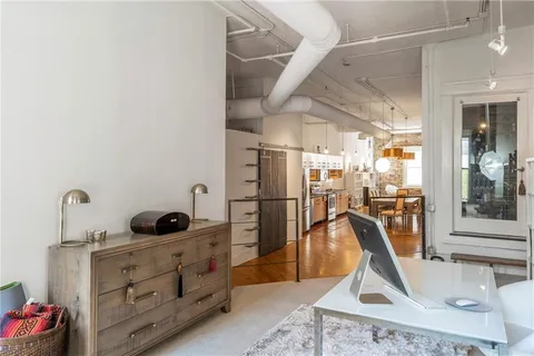 a view of balcony with wooden floor and a potted plant