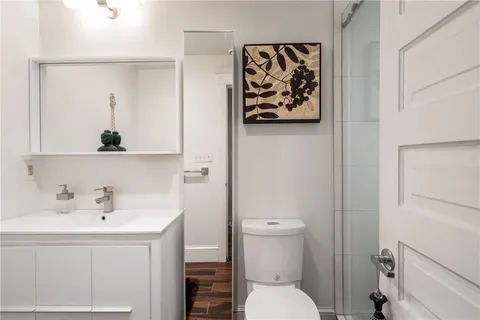 a bathroom with a shower a toilet and sink