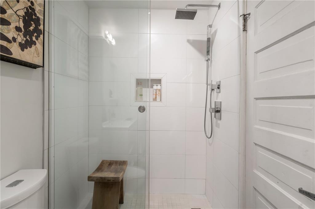 215 Mitchell Street Southwest, Unit 14 Atlanta, GA 30303 - Photo 37 of 37 a bathroom with a shower a toilet and sink