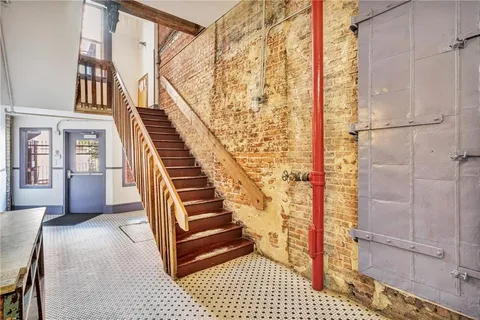 a view of entryway and hall with wooden floor