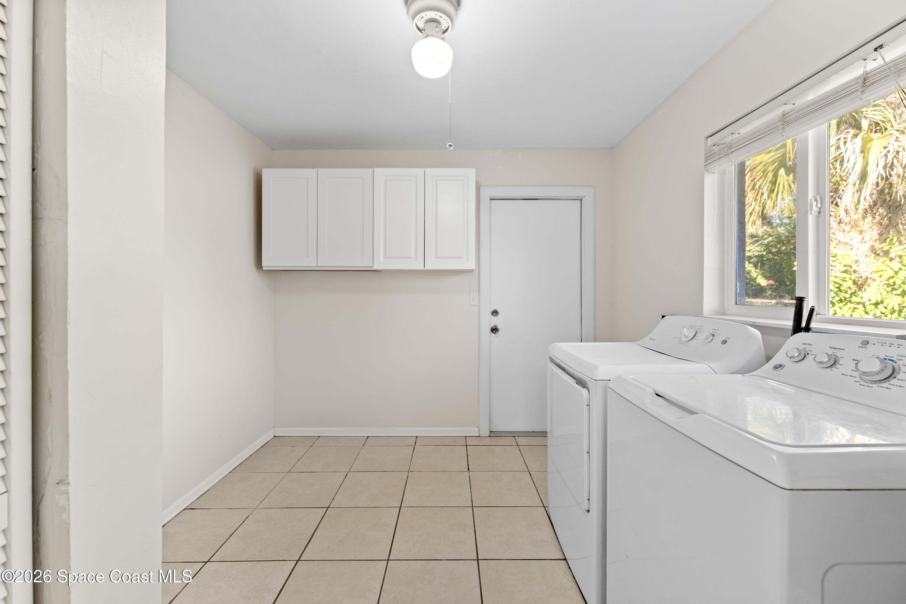 420 South Tropical Trail Merritt Island, FL 32952 - Photo 7 of 20 a view of utility room and bedroom with a window