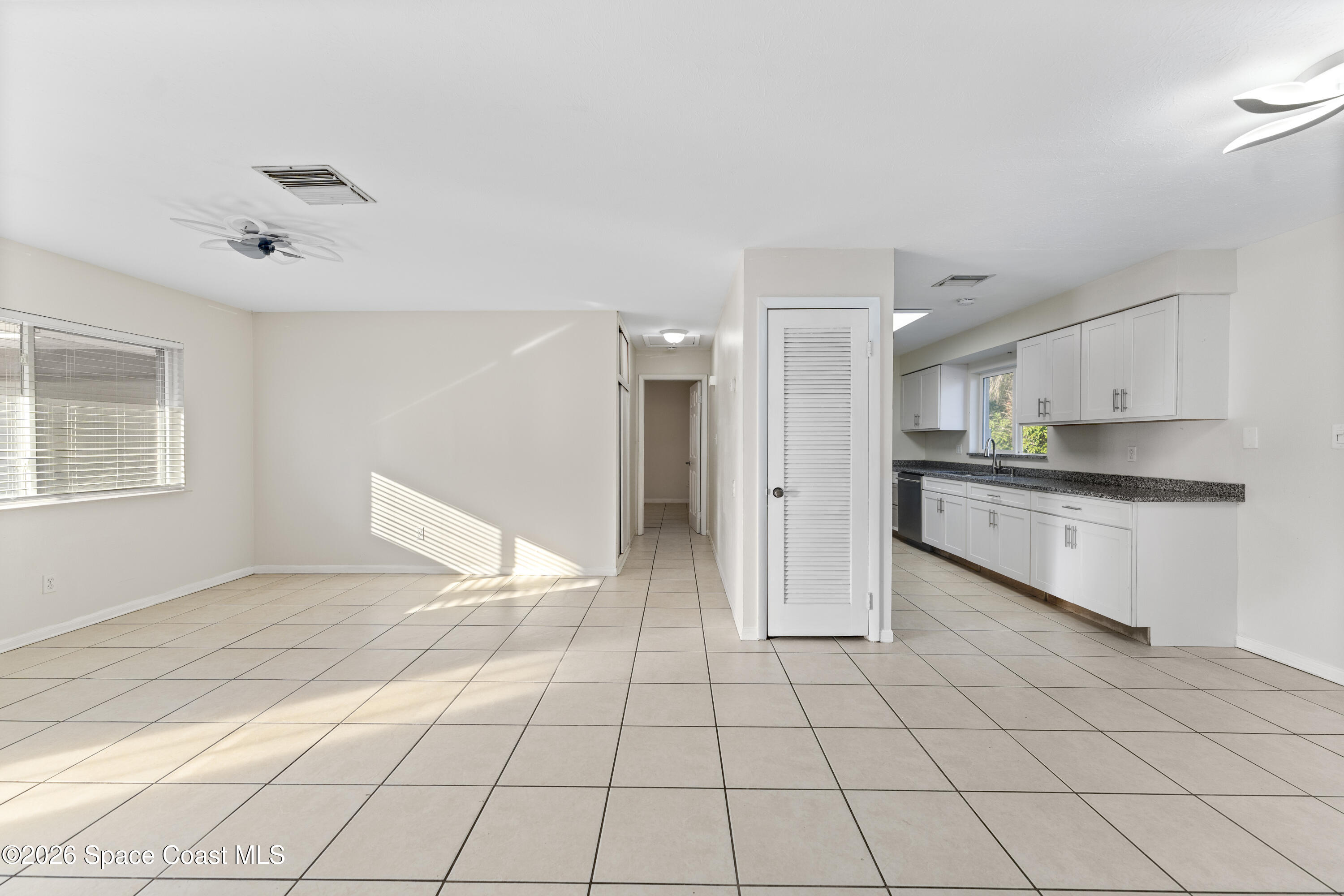 420 South Tropical Trail Merritt Island, FL 32952 - Photo 8 of 20 a view of a kitchen with a sink and a refrigerator