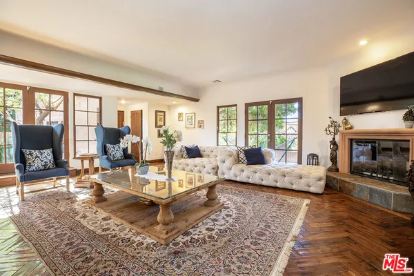 a living room with fireplace furniture and a flat screen tv