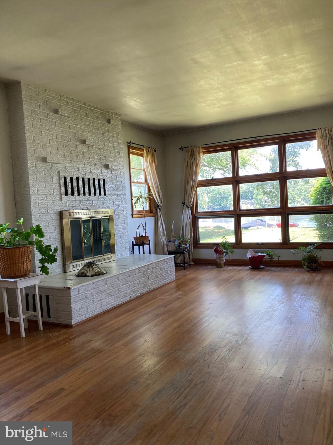 1930 Cedar Road Pasadena, MD 21122 - Photo 9 of 27 Living room with fireplace and more waterviews