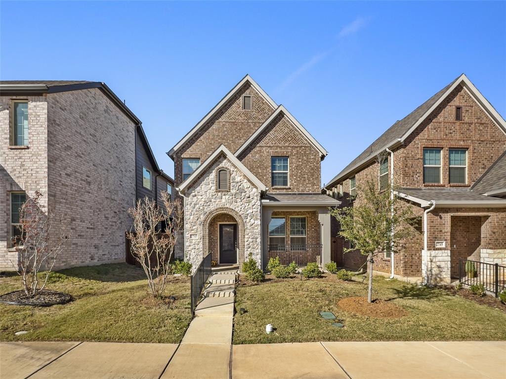 2745 Acadia Drive Corinth, TX 76210 - Photo 1 of 27 a view of a brick house with many windows next to a yard