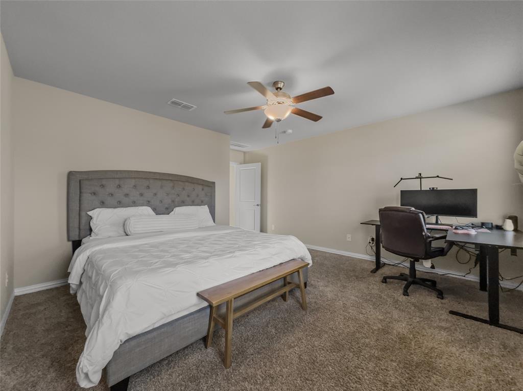 2745 Acadia Drive Corinth, TX 76210 - Photo 13 of 27 a bedroom with a bed and a desk