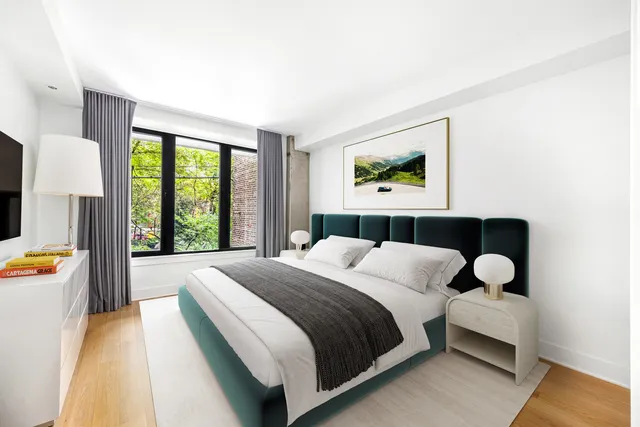 a bedroom with a bed and a large window