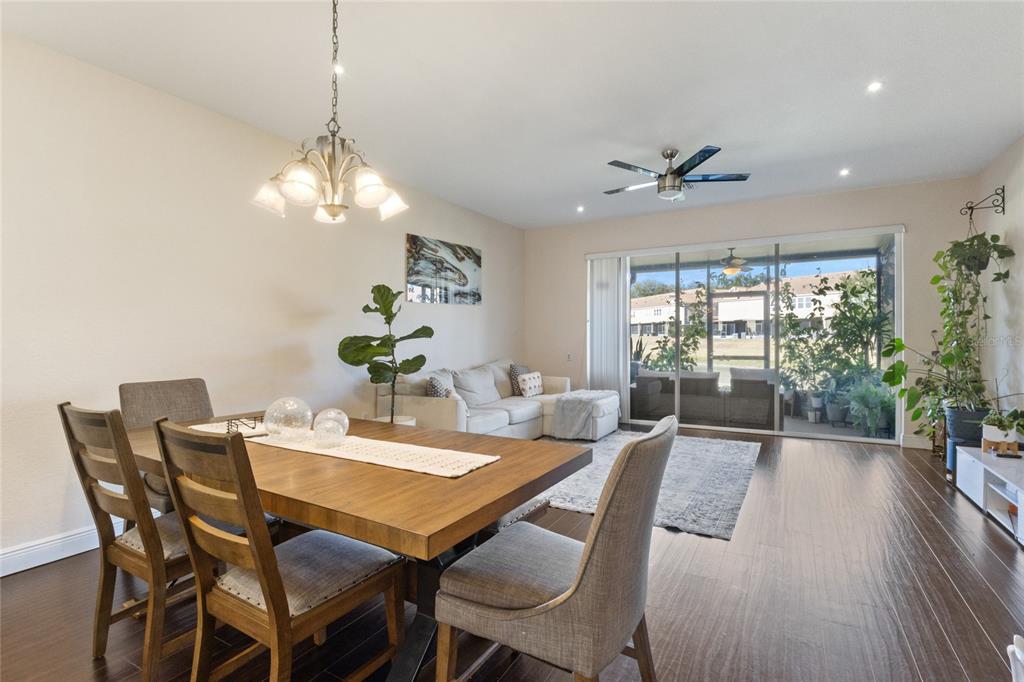6435 Ranelagh Drive, Unit 104 Orlando, FL 32835 - Photo 11 of 36 a view of a dining room with furniture window and wooden floor