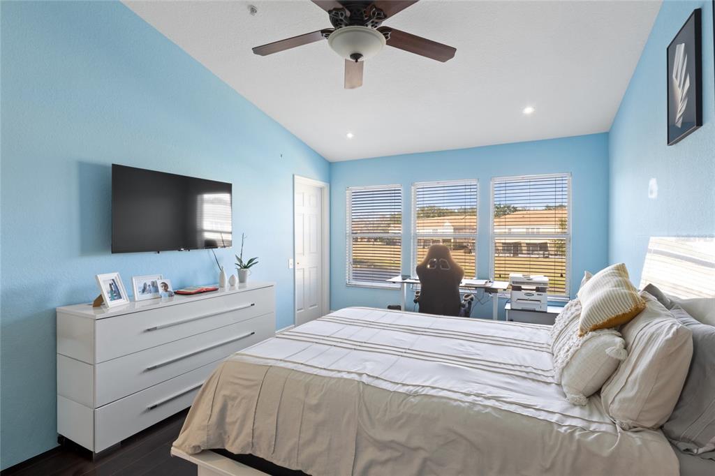 6435 Ranelagh Drive, Unit 104 Orlando, FL 32835 - Photo 17 of 36 a bedroom with a bed and a flat screen tv