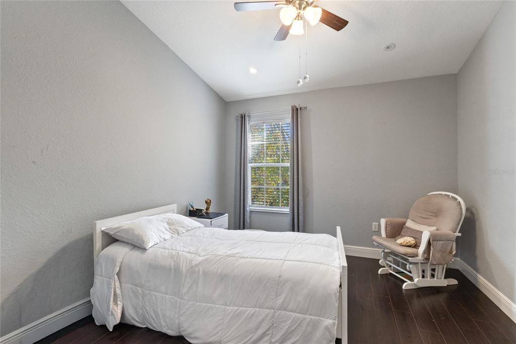 6435 Ranelagh Drive, Unit 104 Orlando, FL 32835 - Photo 22 of 36 a bedroom with a bed chair and window