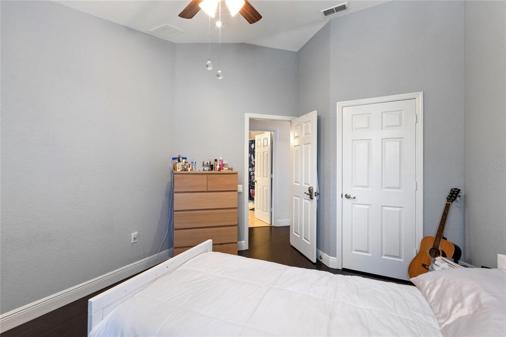 6435 Ranelagh Drive, Unit 104 Orlando, FL 32835 - Photo 23 of 36 a bed room with a bed and a chandelier