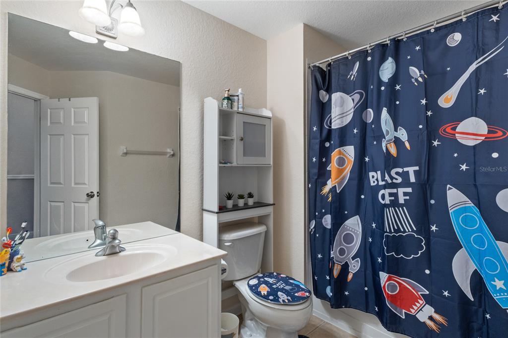 6435 Ranelagh Drive, Unit 104 Orlando, FL 32835 - Photo 25 of 36 a bathroom with a sink and mirror with toilet